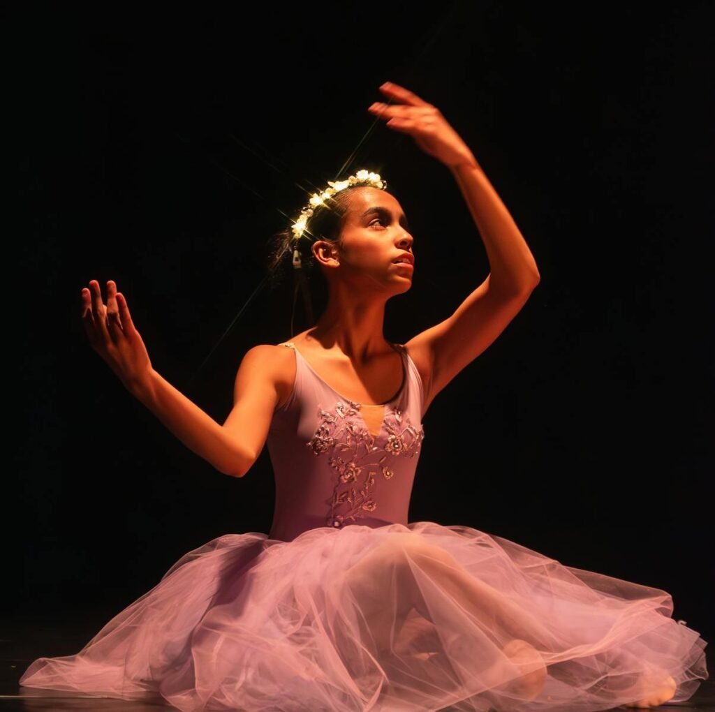 Elegant ballerina in a ballet pose on stage, highlighting grace and poise.
